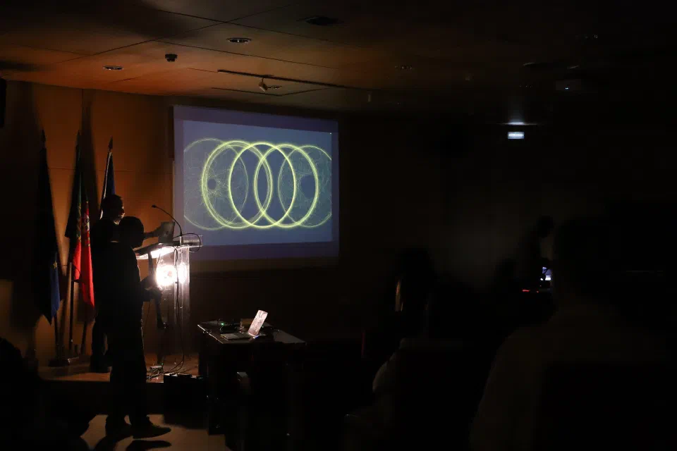 The darkened auditorium, with the generative projection and the audience