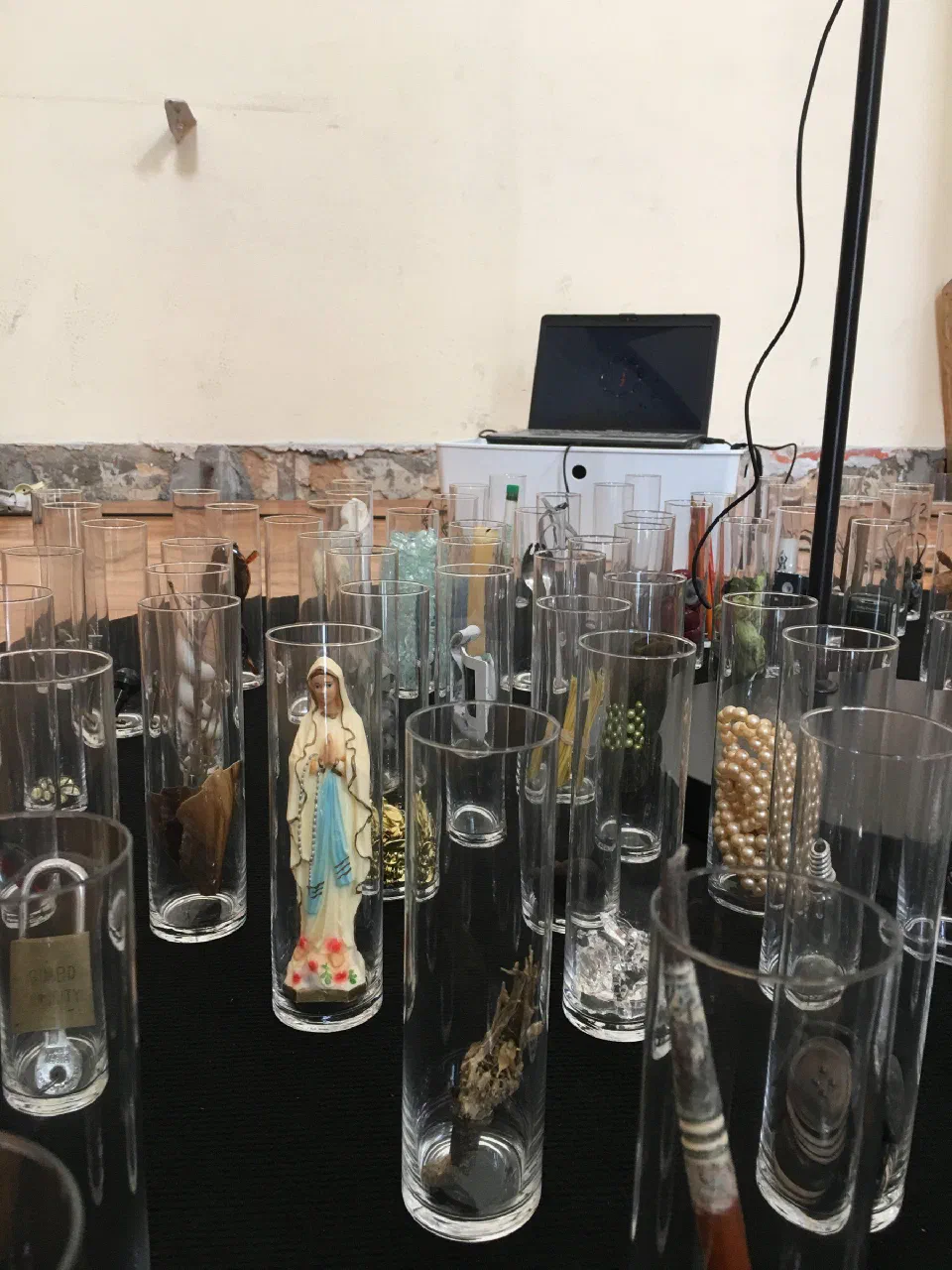 Detail of the OMMANDALA base, with objects inside glass containers